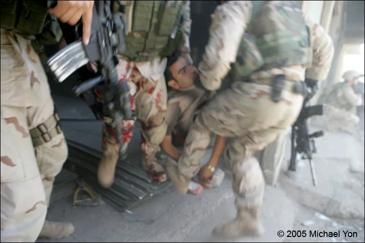 CSM Prosser, his leg drenched in the terrorist’s blood, as 2nd Platoon Alpha Company arrives