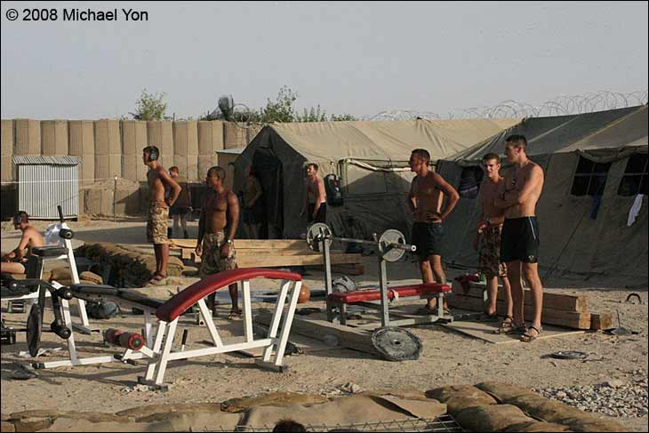 Some soldiers stop working out long enough to watch a 500lb bomb explode.  How many gyms can a man watch a Taliban battle between sets of sit-ups?  That concertina wire in the background marks the beginning of Terry country.