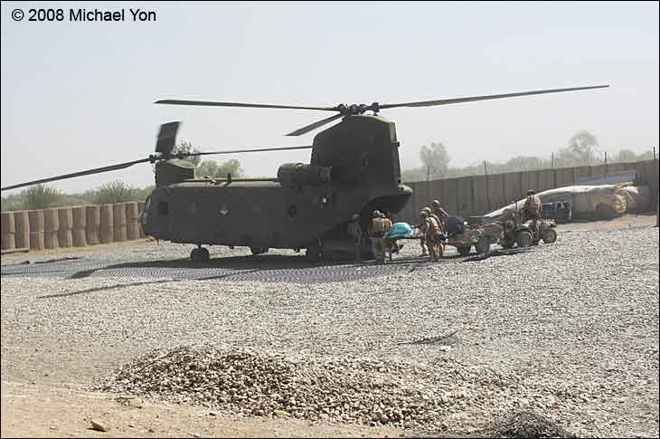 Medical evacuation: ATV with trailer and stretcher rushes Afghan shot by sniper to the helicopter.