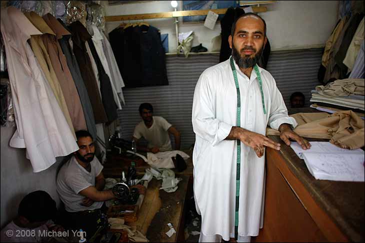 The Tailor’s Shop: They were all smiles and laughter and wanted me to photograph them, but the moment the camera came up, they took a serious pose.  Then they started smiling again, wanting to see the photo.  My shawal kameez (similar to the one the tailor is wearing) will be ready on Thursday.