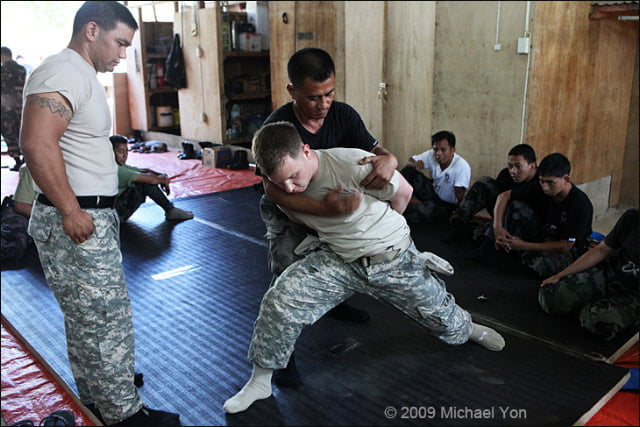 U.S. Army Sergeant Alexander Jamieson is handcuffed and searched during training of Philippine National Police.