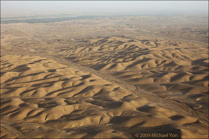 As seen from a British helicopter through my camera between Camp Bastion and Sangin.  The 'Green Zone' in the upper left is the Helmand River Valley.