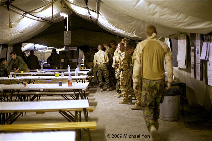 At midnight, soldiers arrived in the mess tent for breakfast.