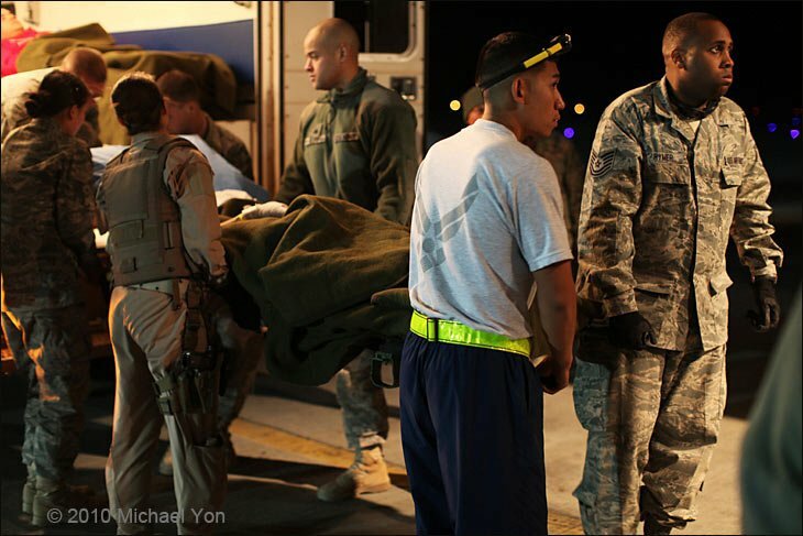 Four wounded US Army soldiers are carried into the C-130J.