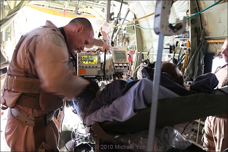 Doctor Chris Ryan works with the wounded Canadian soldier.  During flight from Kandahar to Bastion to Bagram, the team was at his side constantly checking this or that.
