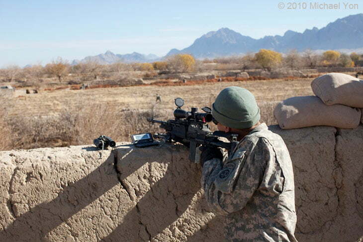 Soldiers can be seen in the field moving closer to the IED.