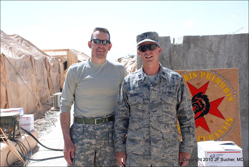 LTC Sam Aldridge (left) and CPT Chad Zielinski (right) stand outside the 909th FST with a new arrival of boxes